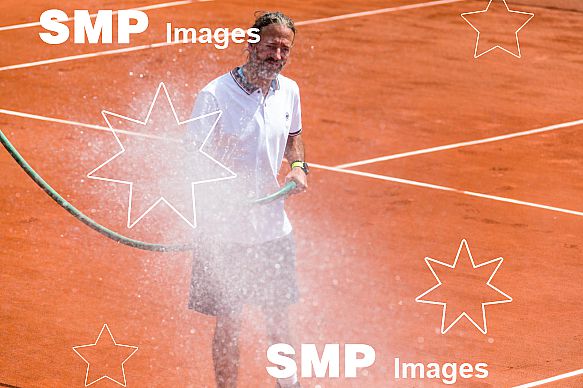 Ground Staff waters the clay court at French Open 2018