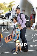 COREY PARKER posing with young fans pre-game
